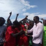 Mr. Ham Namakajjo hands the Adidas Team the Jumia Cup trophy